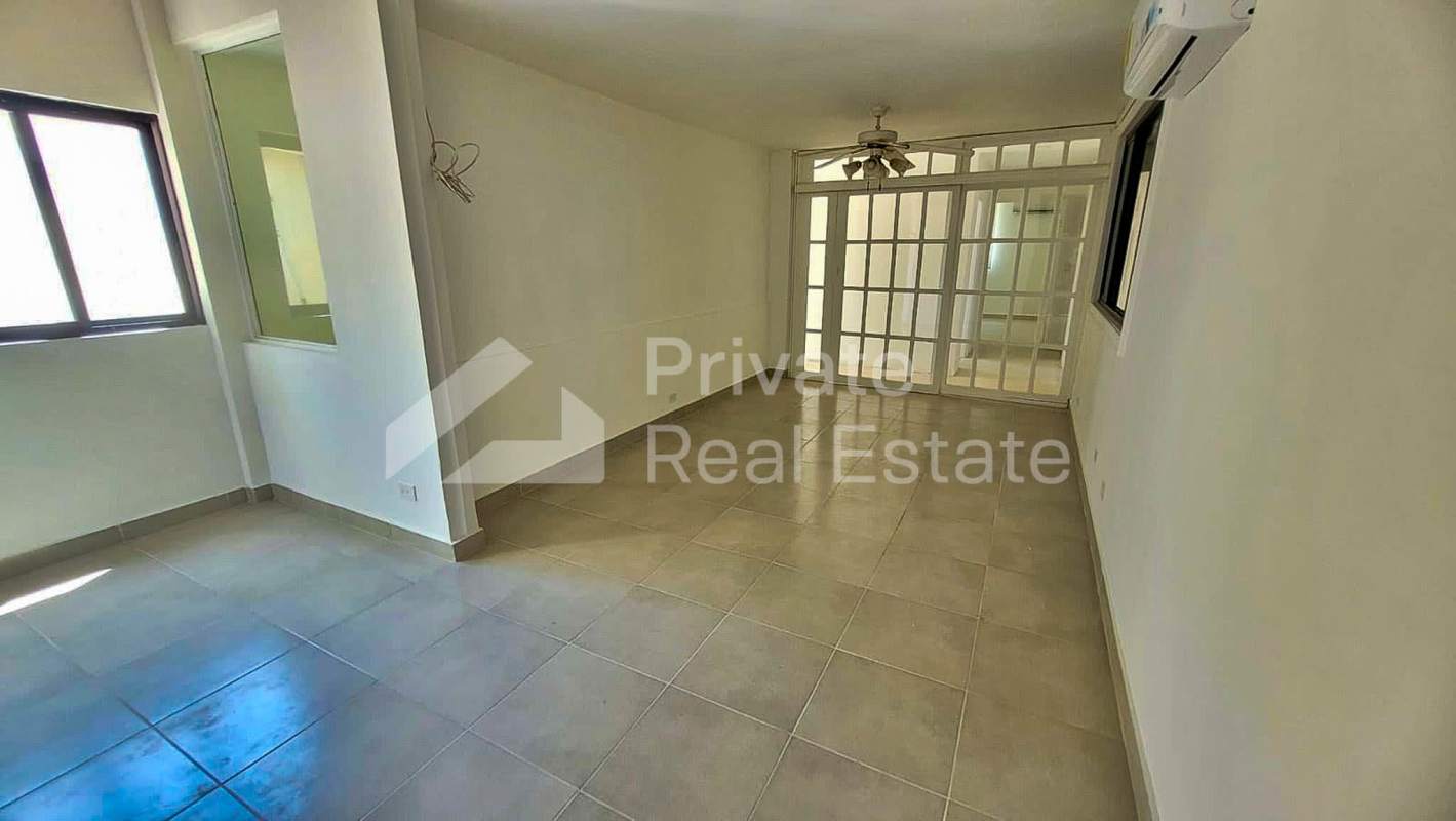 Home office with built-in wooden desk cabinets natural light in Paitilla house Panama