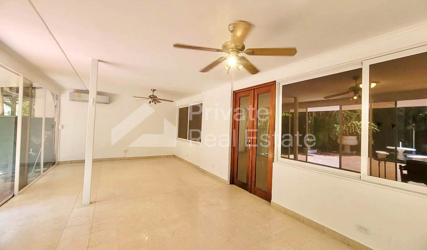 Large granite kitchen with island, wood cabinetry, appliances in luxury house Punta Paitilla Panama