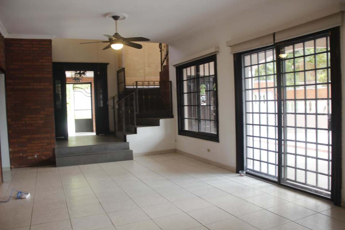 Rustic kitchen dark wood cabinets granite counters terracotta tile Villa de las Fuentes Panama