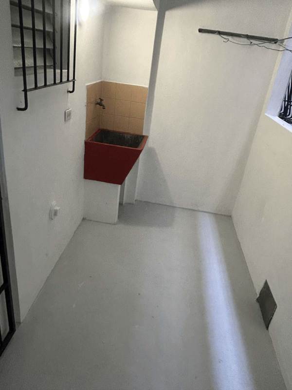 Simple functional laundry area with utility sink and tile backsplash La Loceria Panama