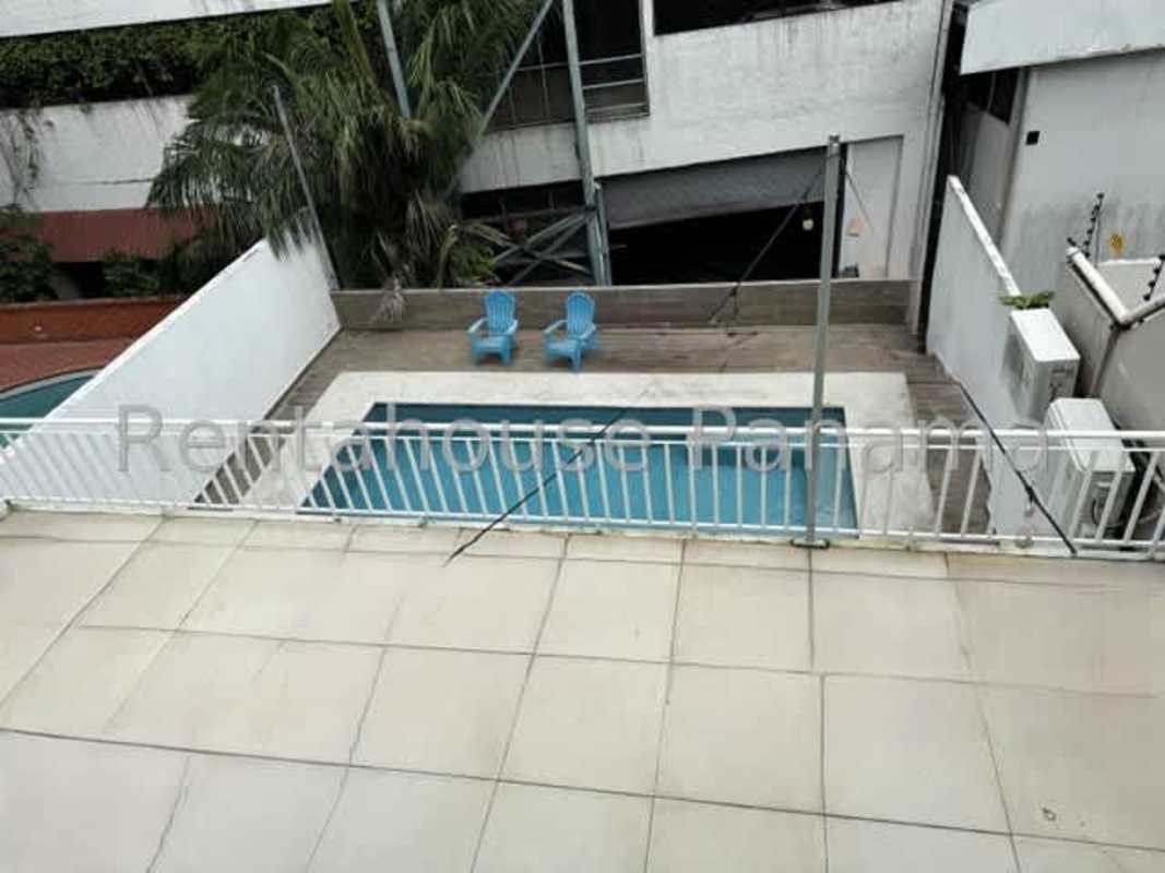 Contemporary living room with large sofa, hammock and glass doors Betania Panama