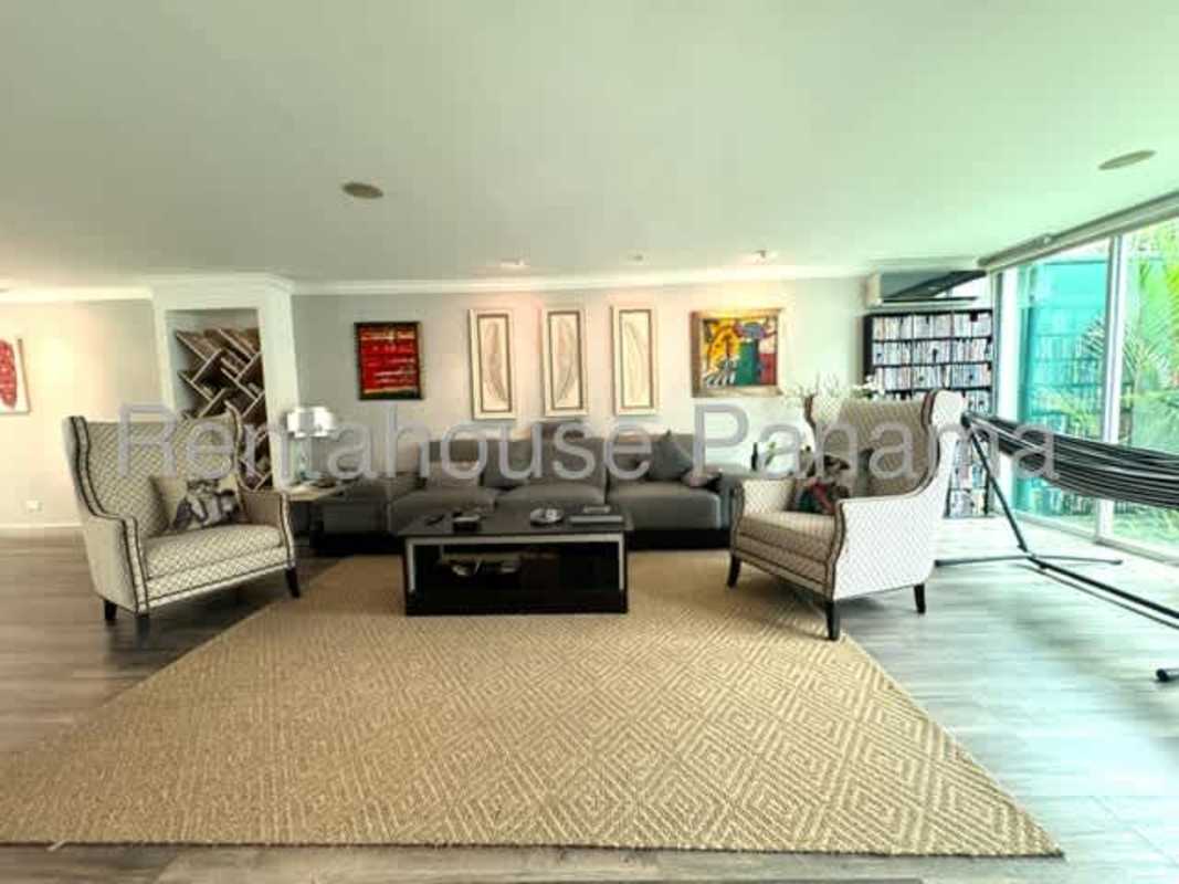 Modern dining space with colorful chairs and glass windows El Dorado Panama