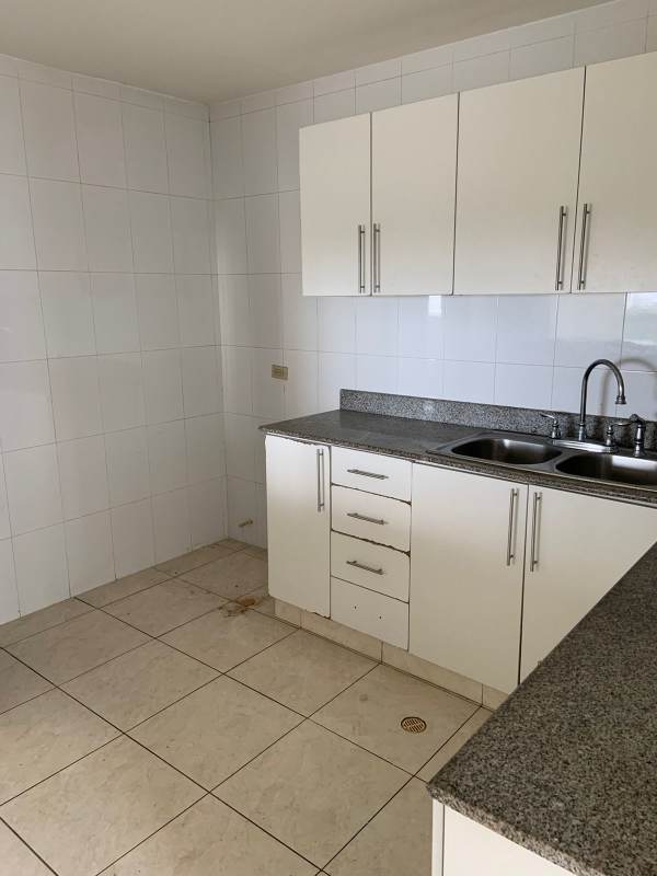 Kitchen with granite countertops and cabinetry in PH Hyde Park apartment Panama City