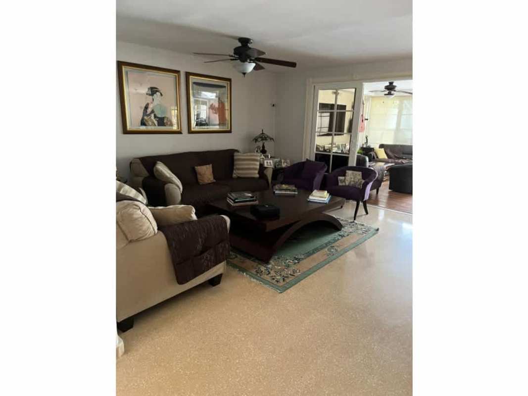 Classic dining room space with large windows, chandelier and seating for eight in Altos del Golf house Panama