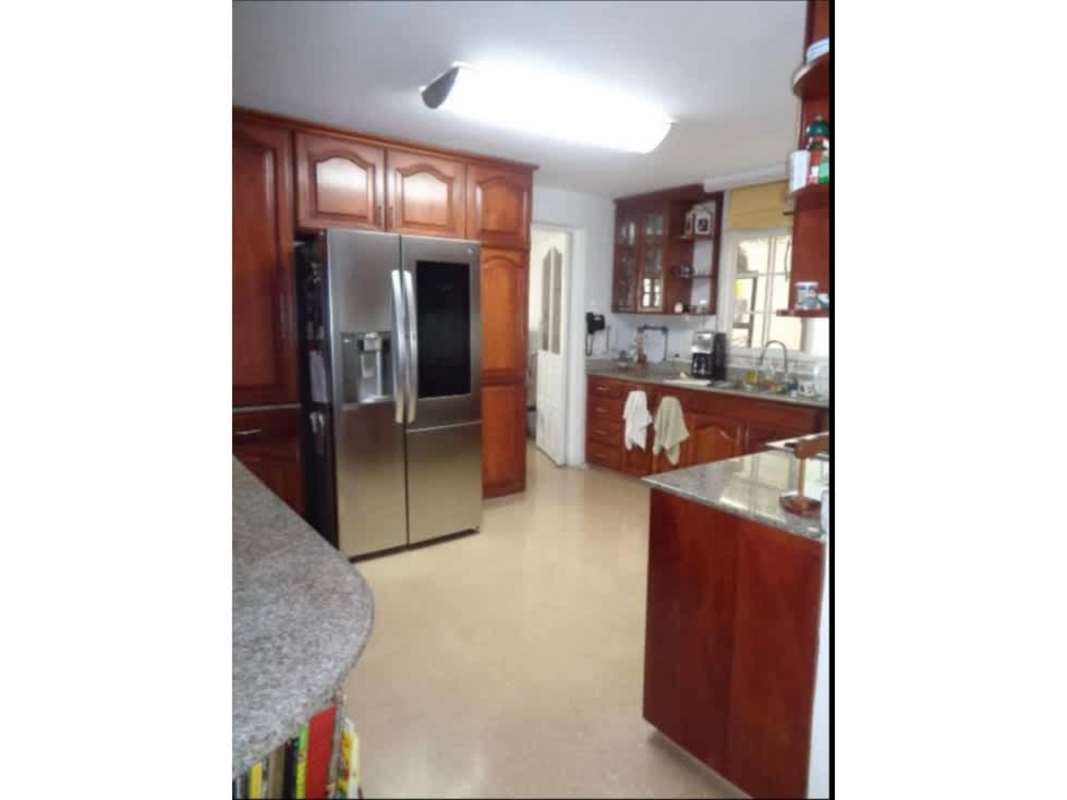 Kitchen with granite counters, wood cabinetry and stainless appliances in Altos del Golf luxury property Panama
