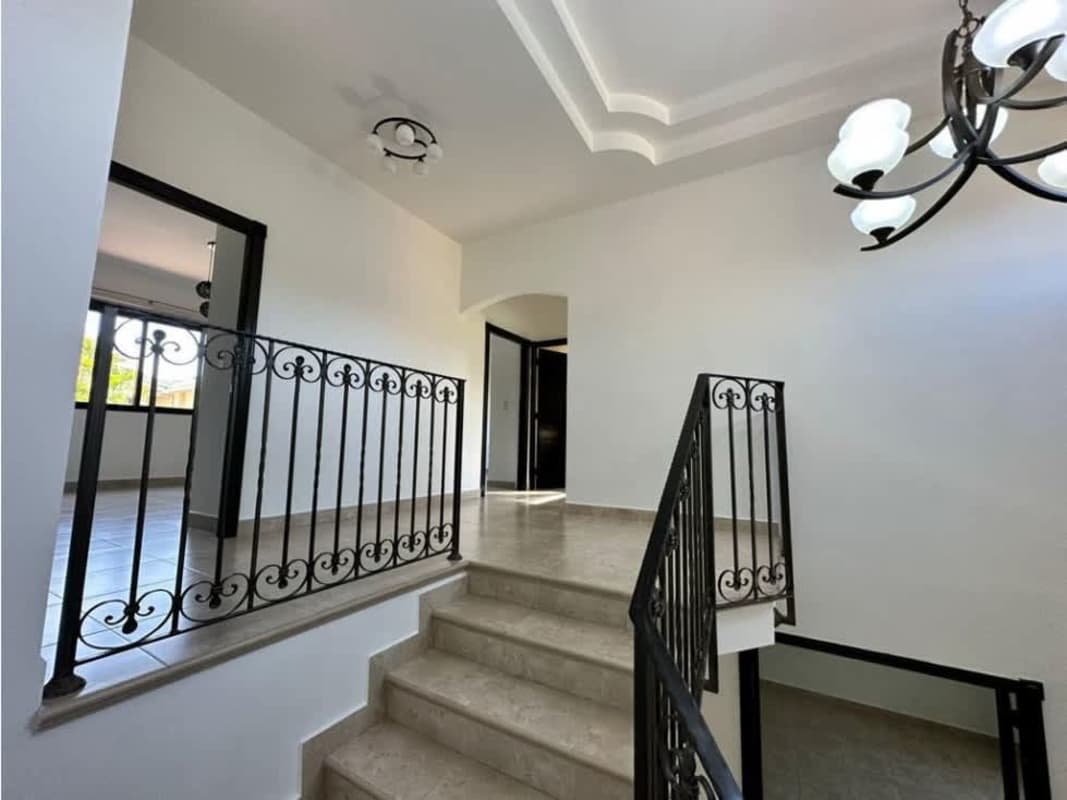 Spacious master bedroom with balcony access and garden view in Costa del Este Panama