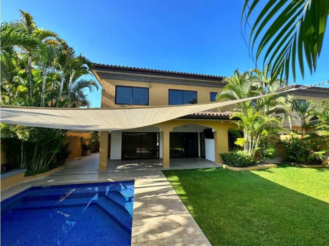 Sparkling private swimming pool with lush tropical landscaping in Costa del Este Panama