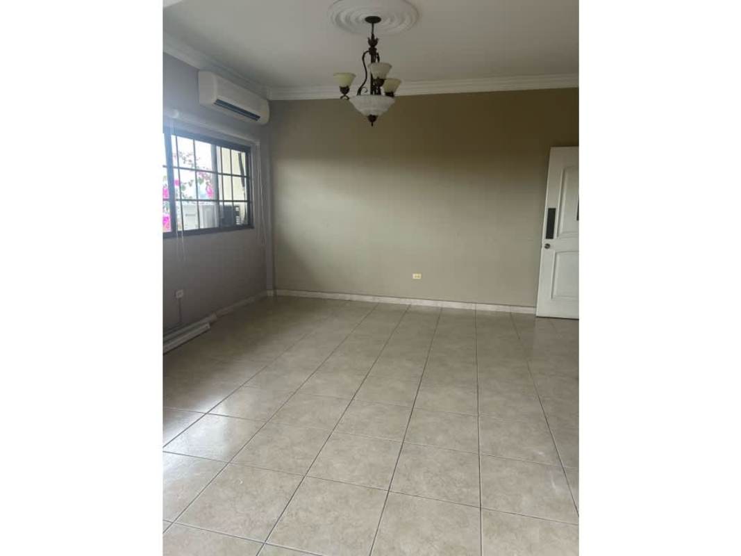 Backyard with artificial turf and shaded patio in Corona Gardens Betania