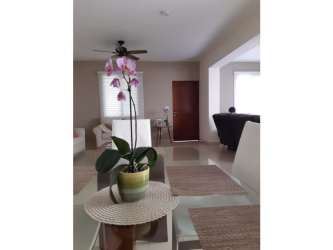 Cozy living room with large windows opening to terrace garden in River Valley Panama Pacifico