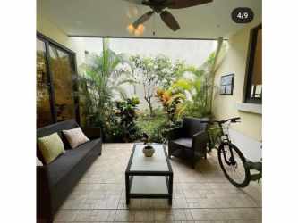 Infinity pool with lounge chairs and tropical landscaping River Valley Panama Pacifico