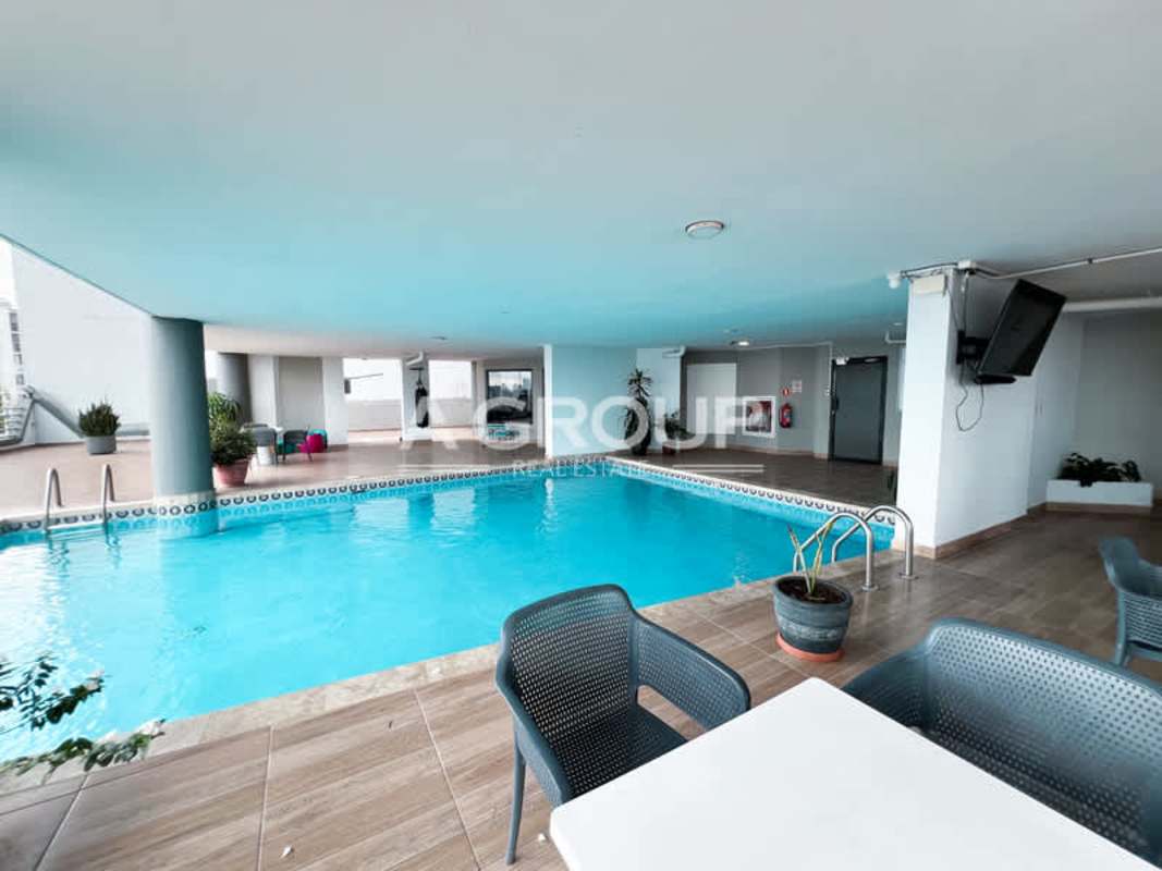 Covered outdoor pool with seating area at PH Sky View in Panama City