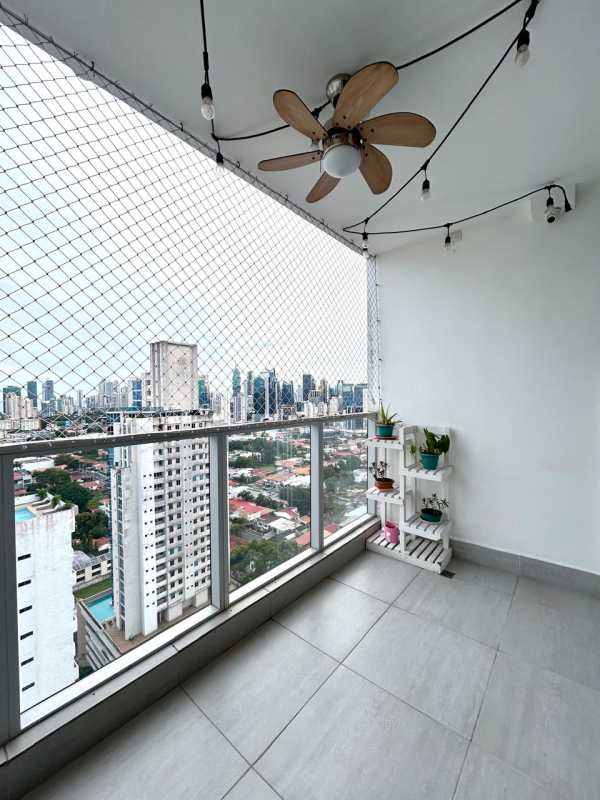 Private balcony with safety net, city skyline view, ceiling fan in PH Jade Tower Panama City