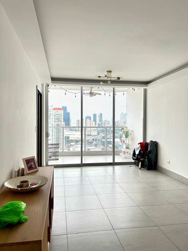 Dining area with glass table, pink chairs, chandelier, porcelain floors in PH Jade Tower San Francisco Panama
