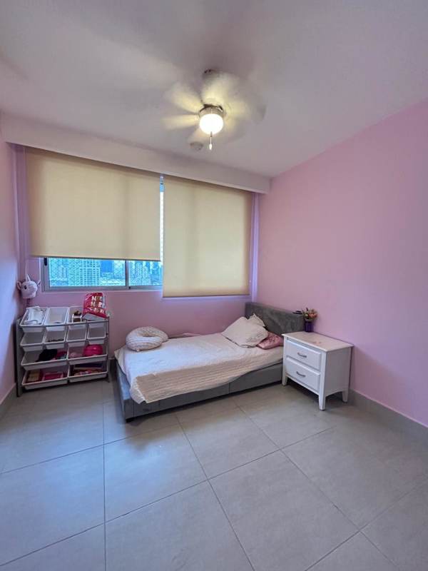 Bedroom featuring large windows, pink accent walls, blinds, and city skyline view in PH Jade Tower San Francisco Panama