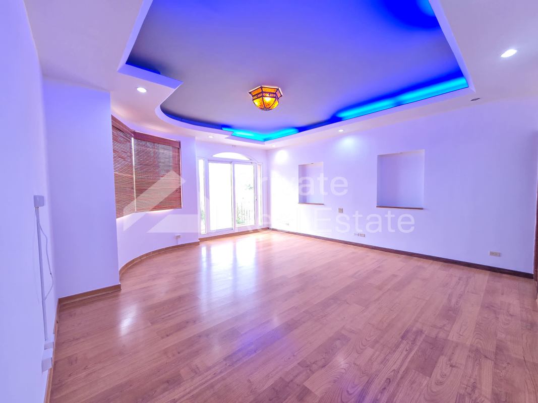 Elegant large living room wood floors recessed lighting balcony San Francisco Panama home