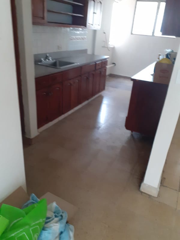 Kitchen with wood cabinets, double sink and large window in apartment PH 12 de Octubre Panama