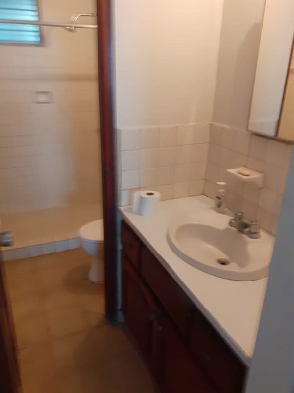 Traditional bathroom with tiled walls, walk-in shower, sink and vanity at PH 12 de Octubre Panama City