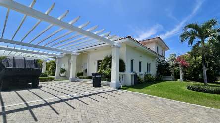 Main entrance of Casamar gated beach community with tropical landscaping