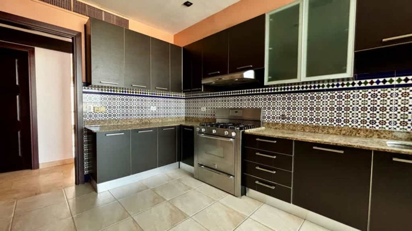Modern kitchen with mosaic backsplash granite countertop appliances Pacific Point Punta Pacifica