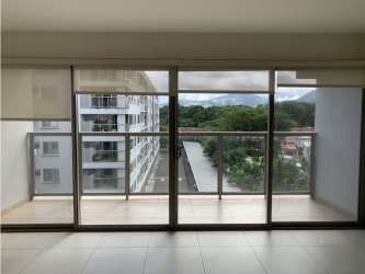 Modern living room with floor-to-ceiling sliding doors leading to balcony at PH Midrise Panama Pacifico