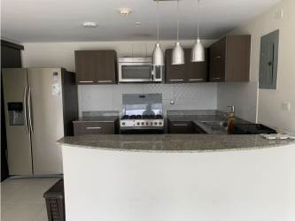 Contemporary kitchen with granite counters and tile backsplash in PH Midrise Panama Pacifico