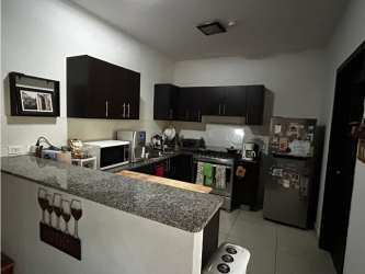 Contemporary kitchen with granite countertops and stainless appliances in Panama Pacifico