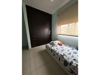 Dining area with six-seat table, ceiling fan, yellow accent wall in Woodlands Panama Pacifico