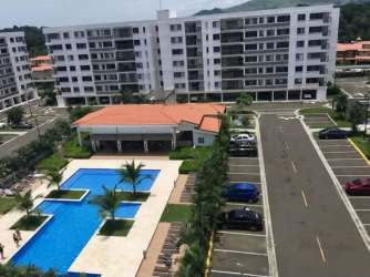 Building exterior of PH Midrise tower with secure covered parking Panama Pacifico