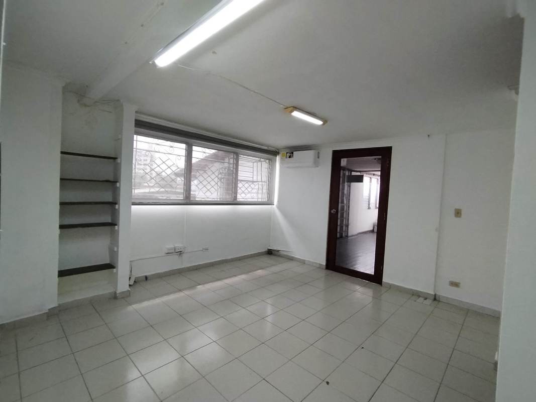 Interior office with large window, security features, and tiled floor