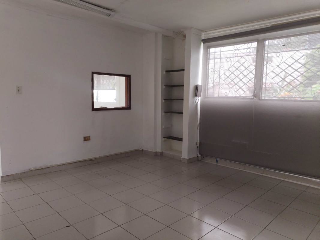 Empty commercial space with large secure window and built-in shelving