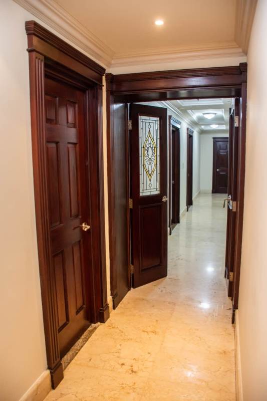 Contemporary kitchen with red cabinetry, granite counters, island seating PH Condesa del Mar Panama
