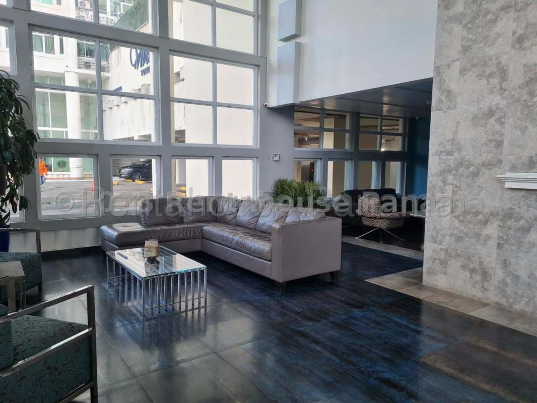Lobby with glass windows, modern sofa and armchairs at PH Vivendi Towers Edison Park Panama City