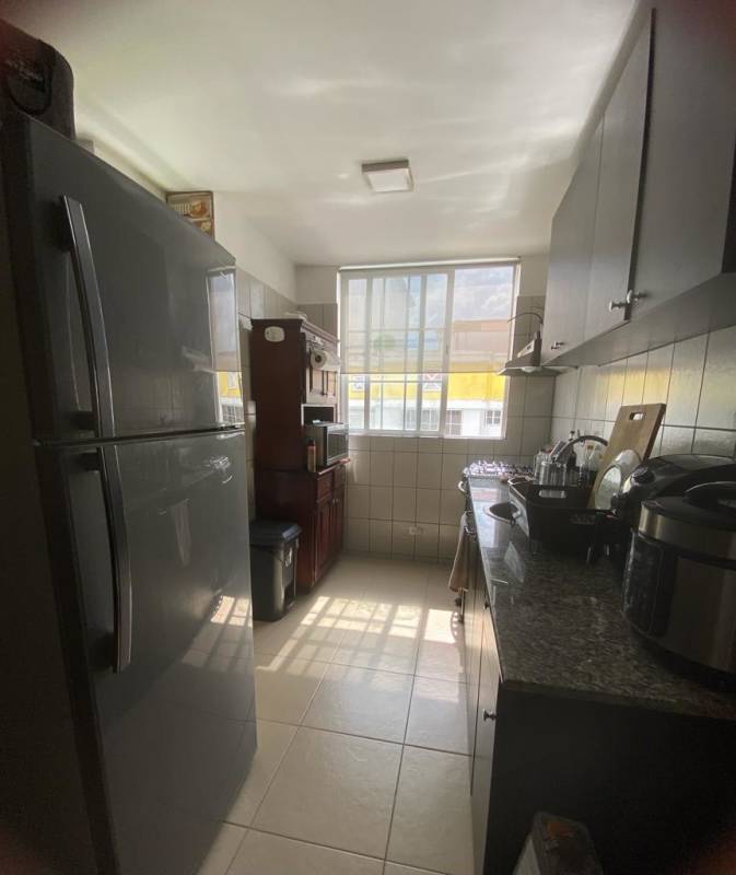 Open concept living and dining area with sliding doors to balcony in PH Mystic Hills.