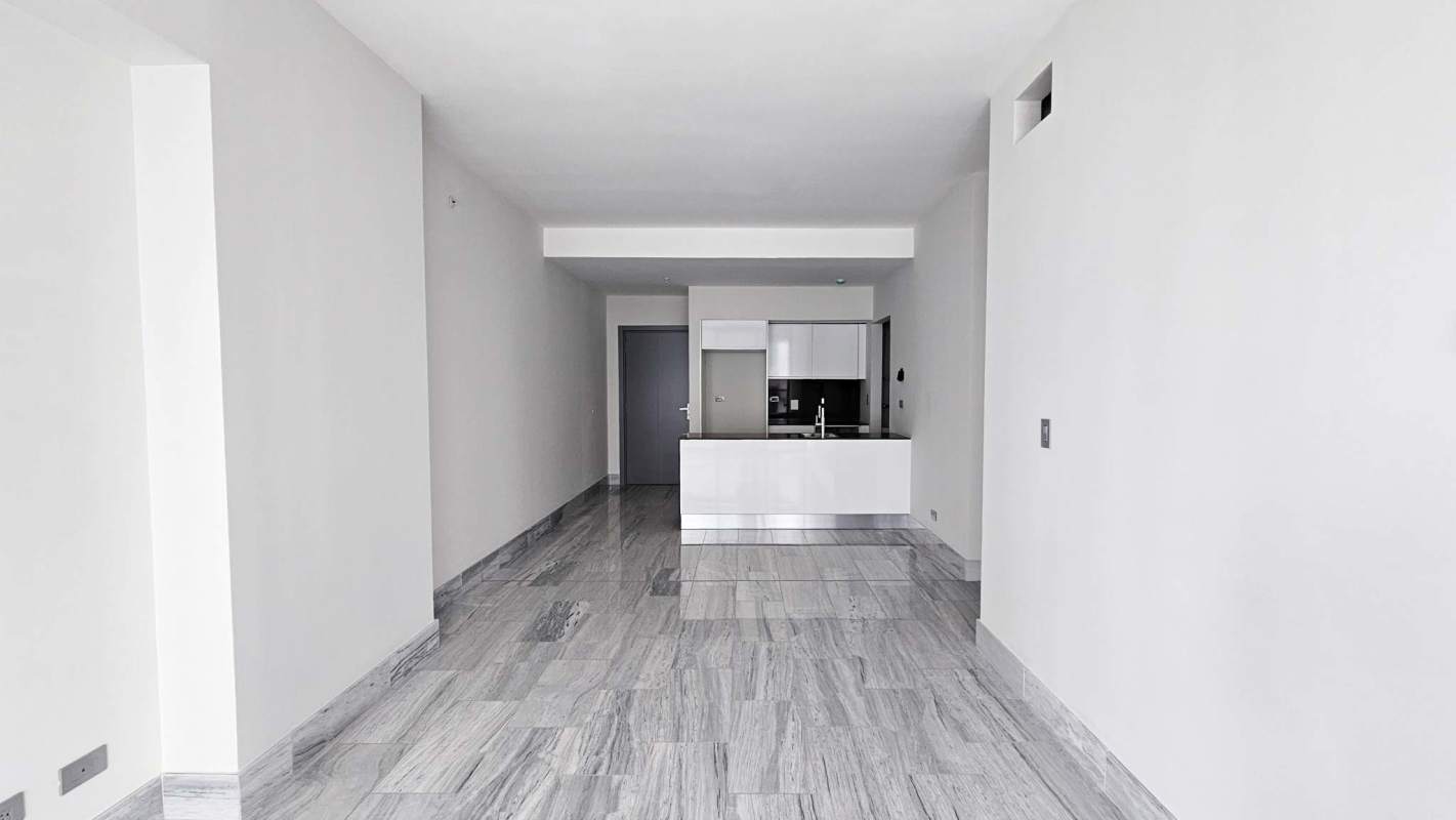 Spacious modern living room with balcony access and panoramic city views at Nuovo by Armani Bella Vista