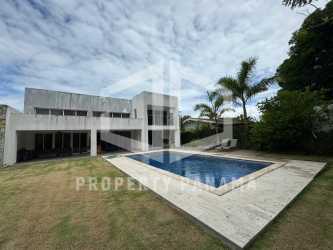 Covered balcony terrace with pool and garden views at Coronado luxury home Panama