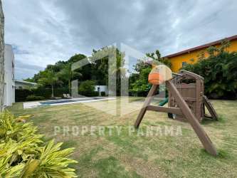 Double-height open living room with large windows garden views Coronado beach house Panama