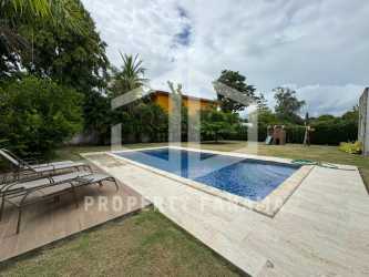 Family-friendly backyard with pool, green lawn, play area in luxury Coronado beach home Panama