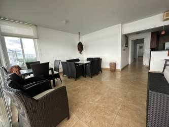 Large bedroom overlooking ocean balcony with natural light at PH Miramar Farallon Panama