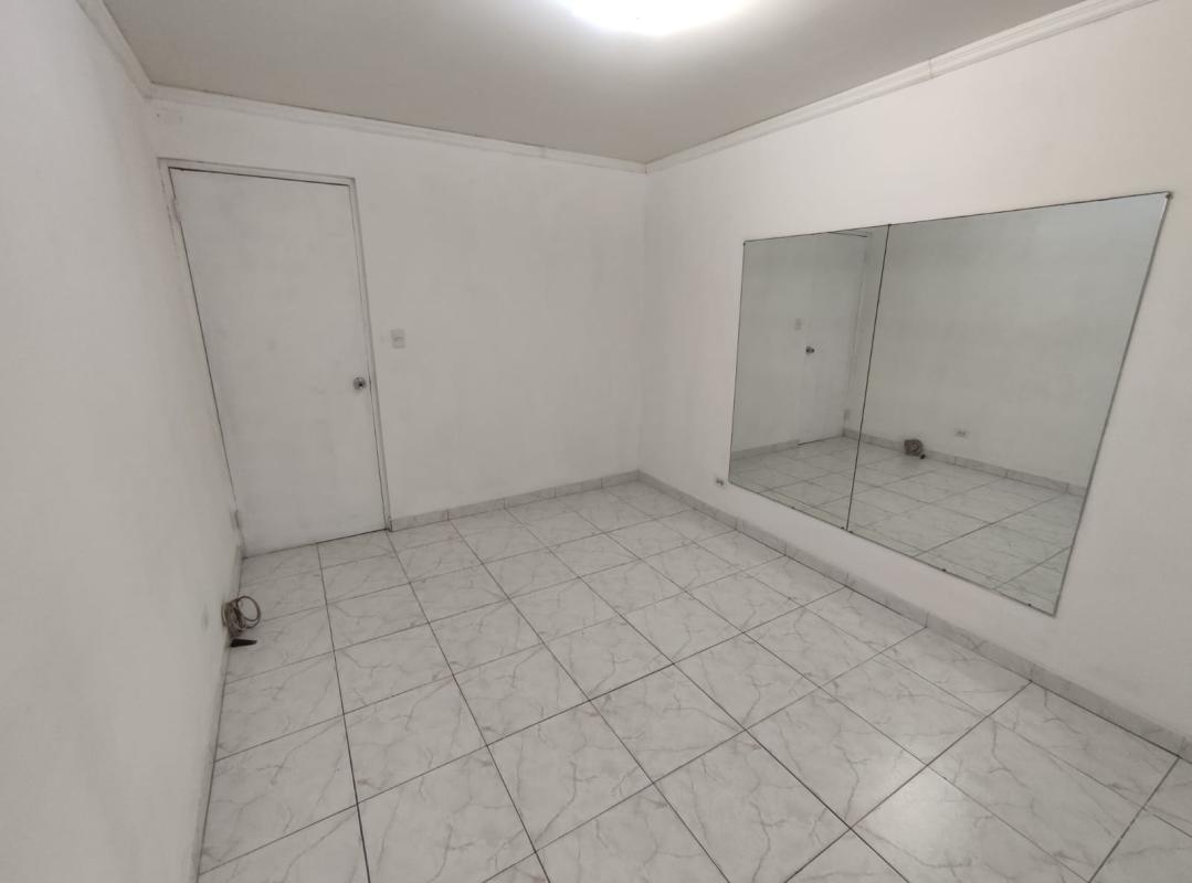 Spacious bedroom with built-in closet, tile floor at PH Vista Serena San Francisco Panama