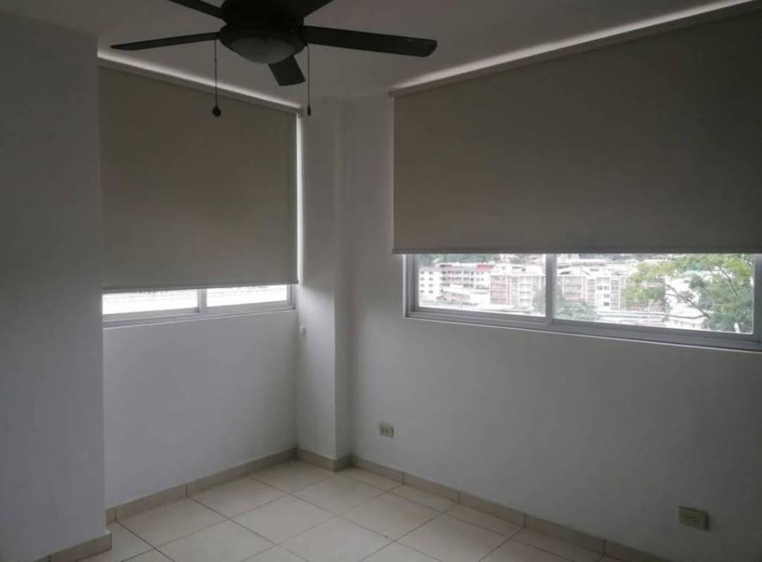 Bedroom with white walls roller blinds ceiling fan large window PH Altamira Carrasquilla Panama