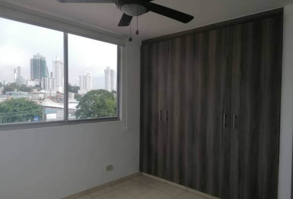 Bedroom with large window city view roller blinds ceiling fan PH Altamira Carrasquilla Panama