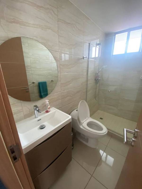 Modern bathroom with beige tiles, vanity and shower in PH Torres de Castilla Panama City