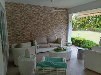 Spacious living room with modern decor large windows in Bijao Villa de Miraflores beach house Panama