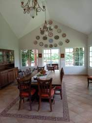 Elegant arched hallway white walls artwork Mediterranean design Coronado Beach Panama home