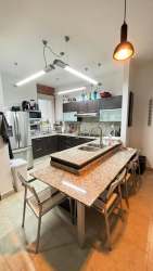 Open concept living and dining space with large windows and balcony access at Vista Mar Resort Panama