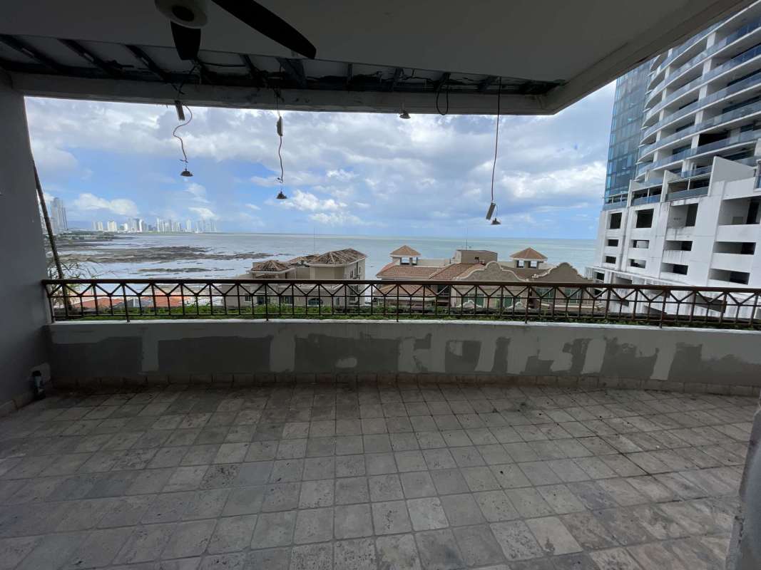 High-end kitchen with island, dark cabinetry, stainless steel appliances ocean and city view PH Pacific Point Panama