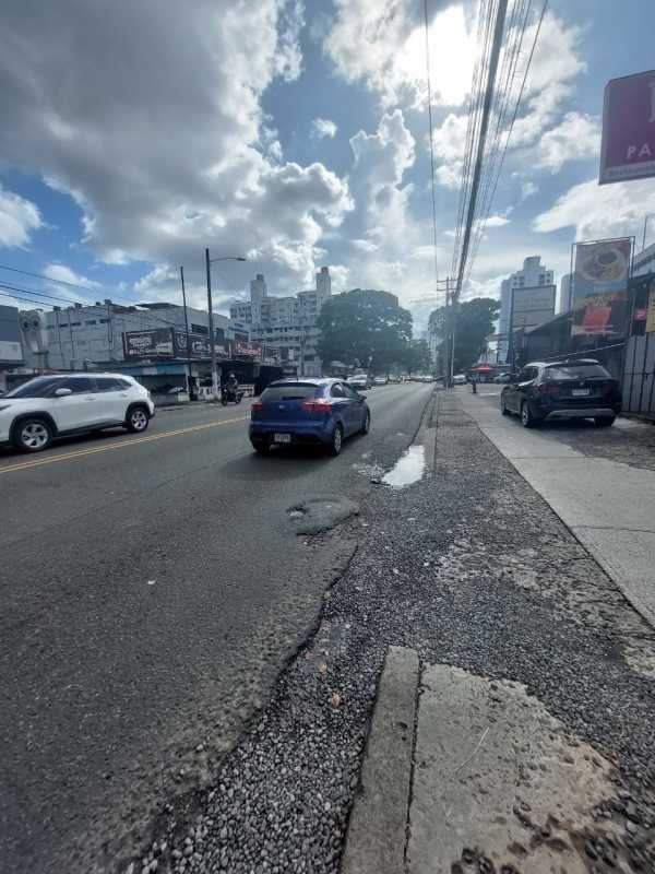City street with commercial buildings and traffic in Rio Abajo Panama