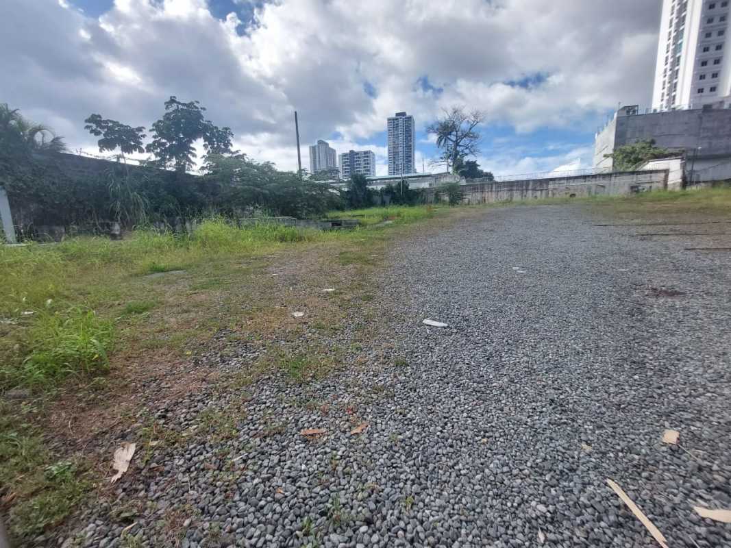 Vacant lot surrounded by urban skyline in Panama City commercial zone