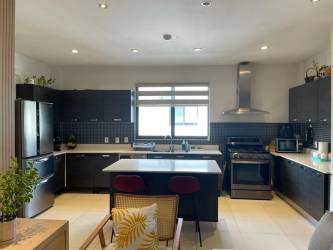 Contemporary kitchen with granite countertops, stainless steel appliances in River Valley apartment Panama