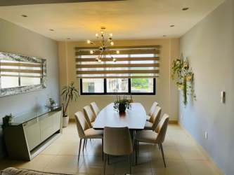 Secondary bedroom with large window, neutral decor in River Valley apartment Panama Pacifico